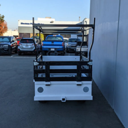 Black metal stake sides mounted on a white flatbed utility golf cart, showcasing the STAKE-SIDES-44X72X18 Flatbed Golf Cart Stake Sides with custom fabrication for golf carts.