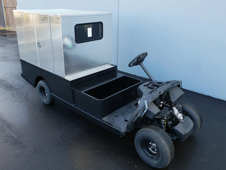 Custom fabricated flatbed utility golf cart with black chassis and FMB-44X72X48-D-D3W3 FLATBED ALUMINUM DIAMOND PLATE MULTI-PURPOSE BOX 44″ WIDE X 72″ LONG X 48″ TALL WITH LOCKING DOORS ON REAR, LEFT AND RIGHT SIDE for cargo and storage.