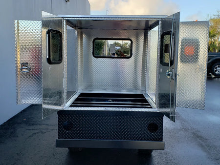 Open flatbed box made of diamond plate aluminum with three locking doors and windows, shown empty from the rear, custom fabrication for golf carts, FMB-44X72X48-D-D3W3 FLATBED ALUMINUM DIAMOND PLATE MULTI-PURPOSE BOX 44″ WIDE X 72″ LONG X 48″ TALL WITH LOCKING DOORS ON REAR, LEFT AND RIGHT SIDE