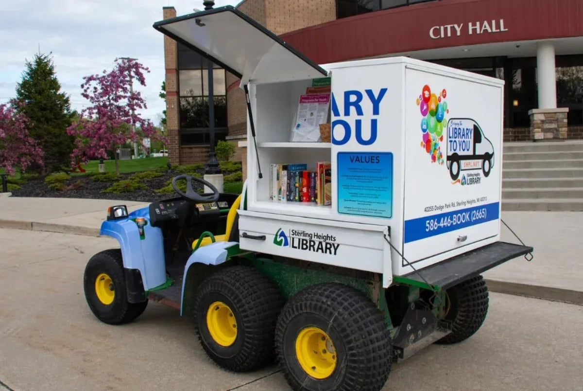 JD-TH6X4-37X47-S3FD-RB Rear Library Box for John Deer TH 6X4 with three doors mounted on a custom fabricated golf cart equipped for mobile book lending.